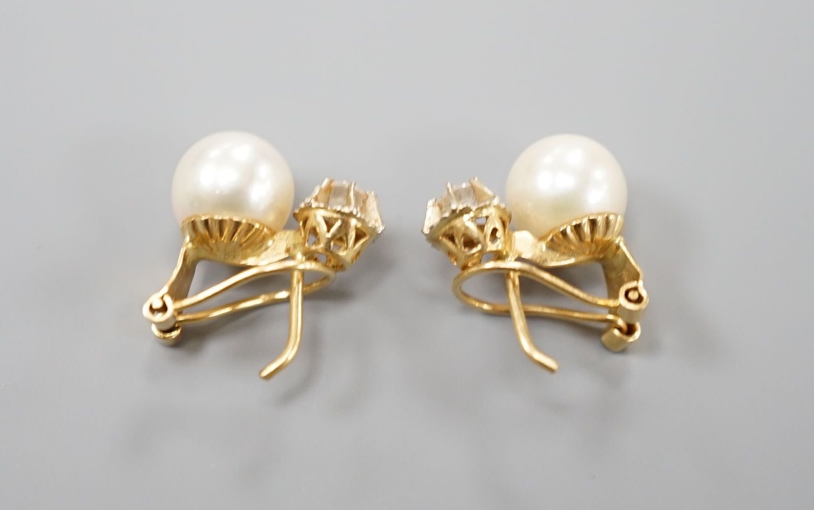 A modern pair of Italian 750 yellow metal, culture pearl and diamond set earrings, 14mm, gross weight 4.2 grams.